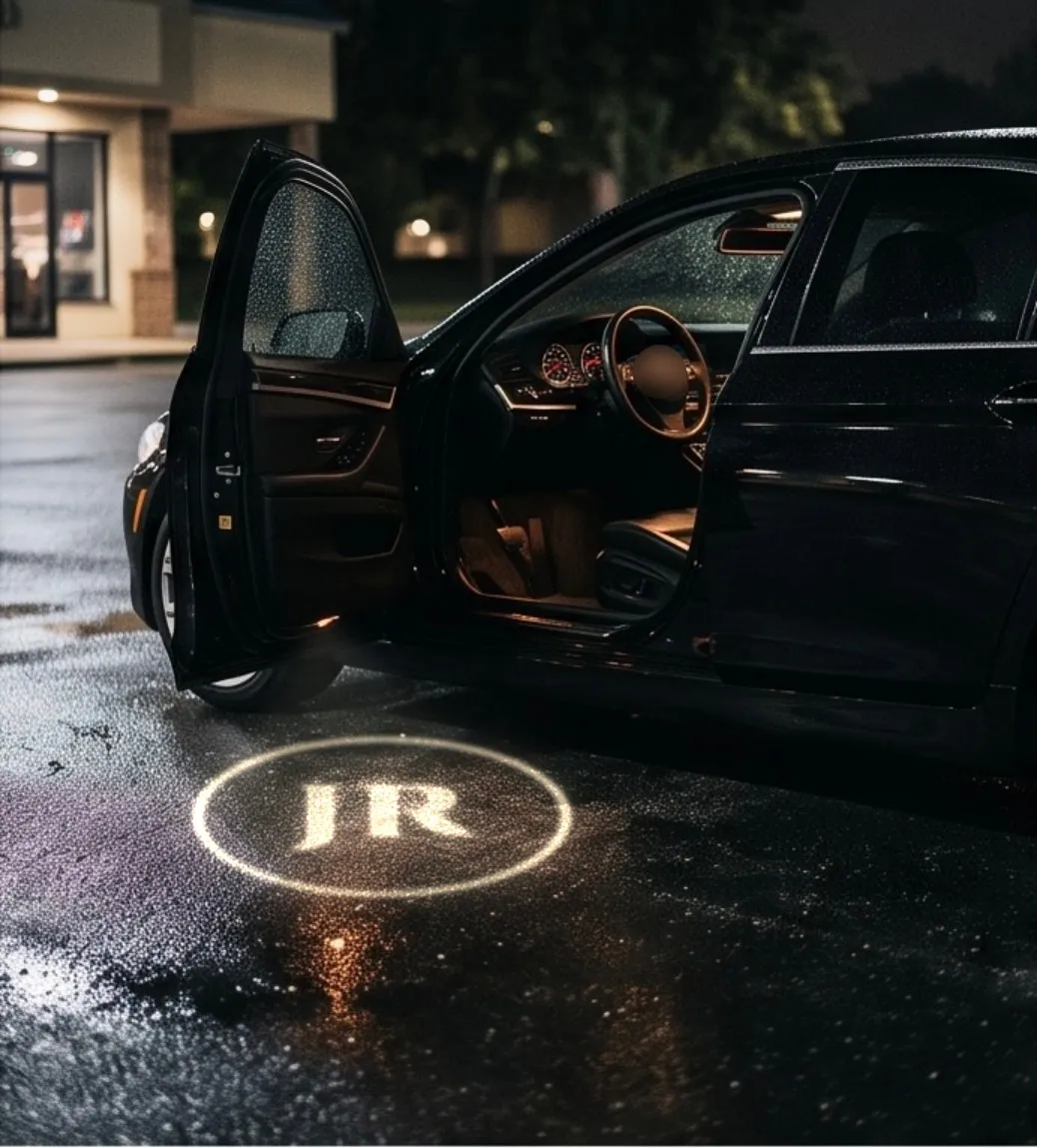 Initials glowing on the ground under an open car door