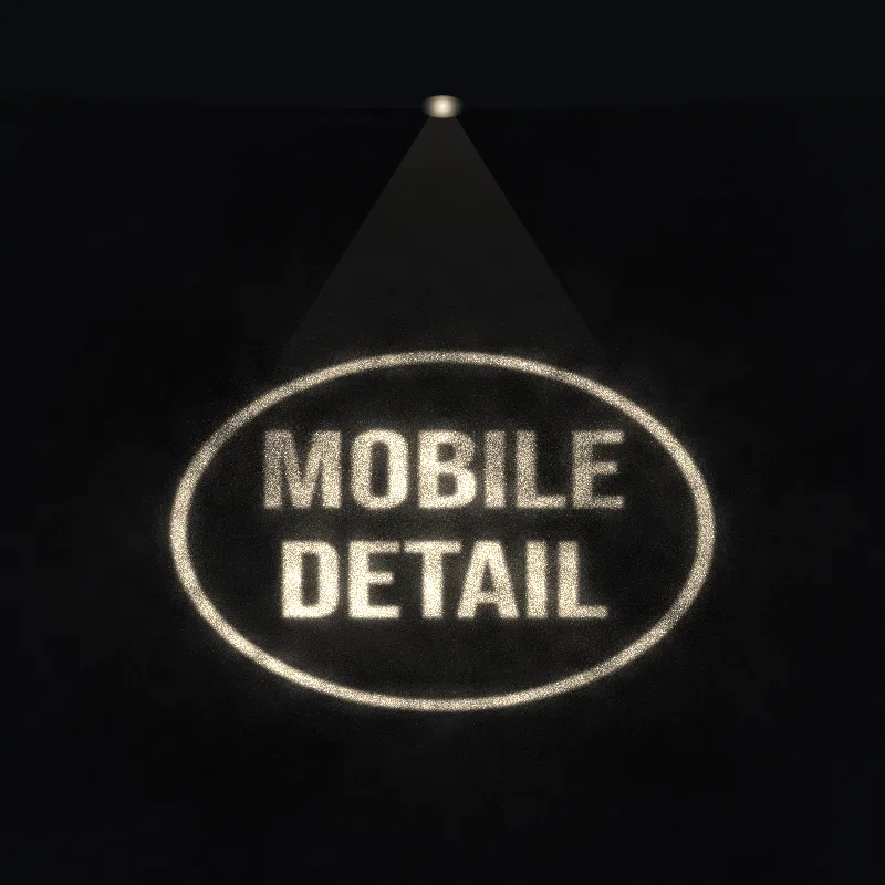 Sample shop logo reading Mobile Detail, glowing on asphalt